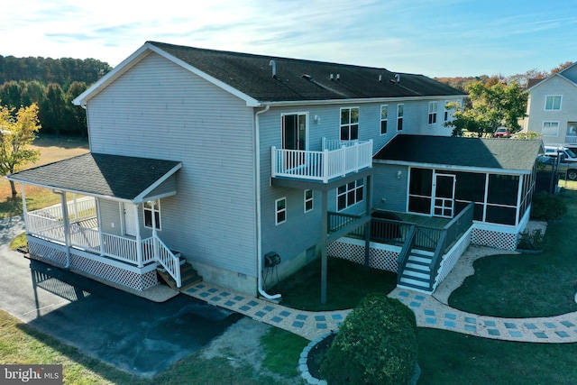 back of property with a sunroom