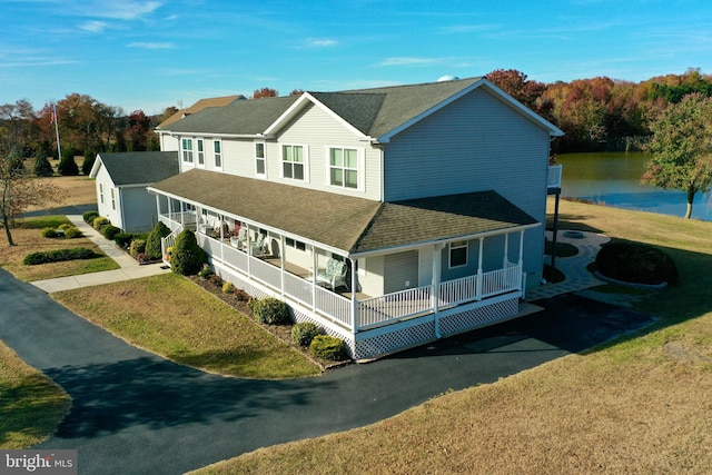 view of front of property with a front yard and covered porch