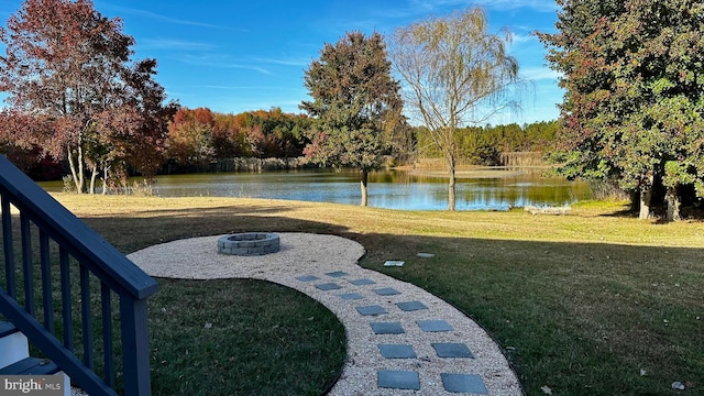 view of yard with an outdoor fire pit and a water view