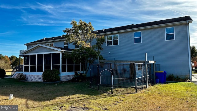 back of house featuring a sunroom and a yard