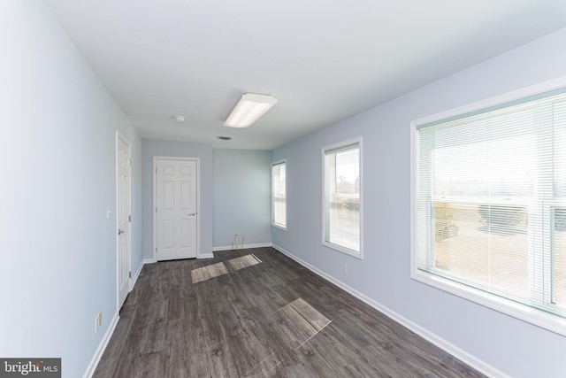 spare room with dark hardwood / wood-style floors