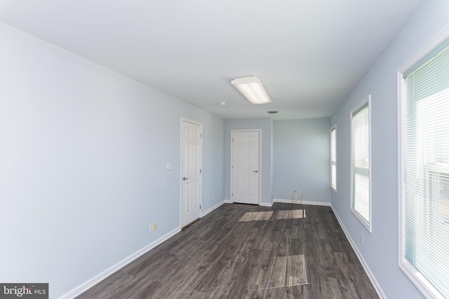 unfurnished room featuring dark wood-type flooring