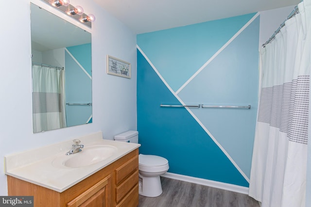 bathroom with toilet, a shower with curtain, vanity, and hardwood / wood-style flooring