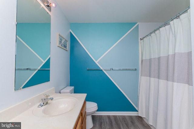 bathroom featuring vanity, hardwood / wood-style flooring, toilet, and a shower with shower curtain