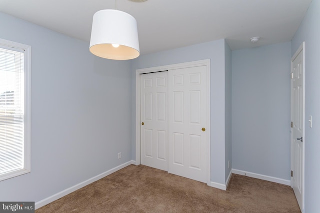 unfurnished bedroom with a closet and carpet floors