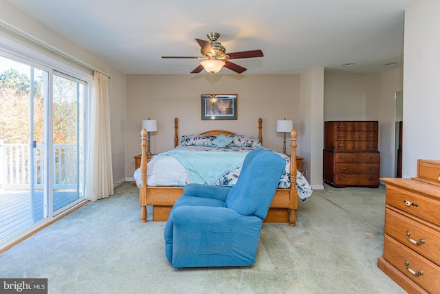 bedroom with access to exterior, light colored carpet, and ceiling fan