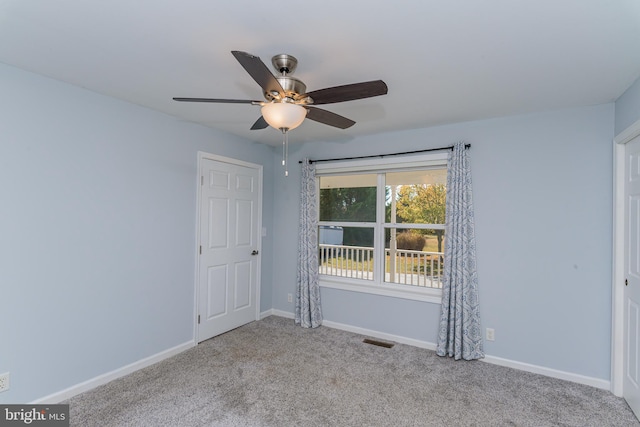 unfurnished room with light colored carpet and ceiling fan