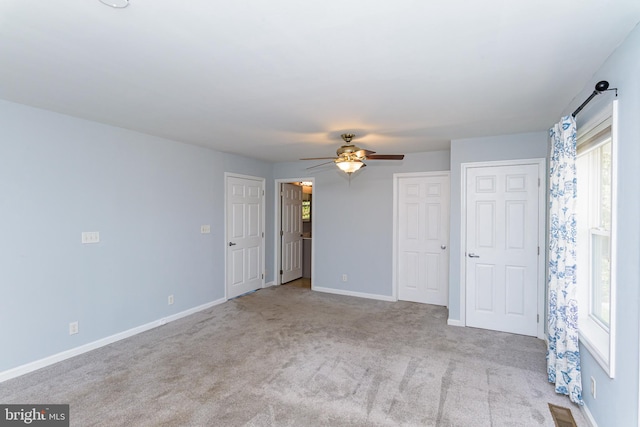 spare room with light carpet and ceiling fan