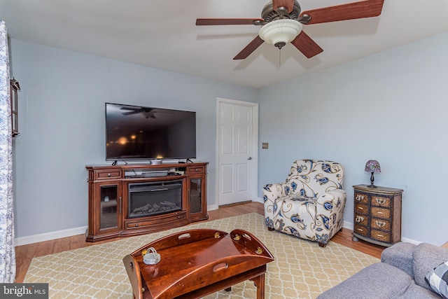 living room with ceiling fan and light wood-type flooring