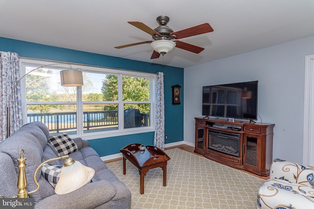 living room with a wealth of natural light and ceiling fan