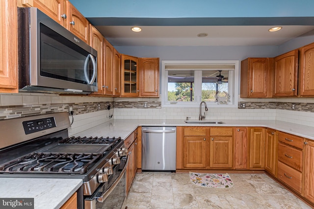 kitchen featuring appliances with stainless steel finishes, sink, and backsplash