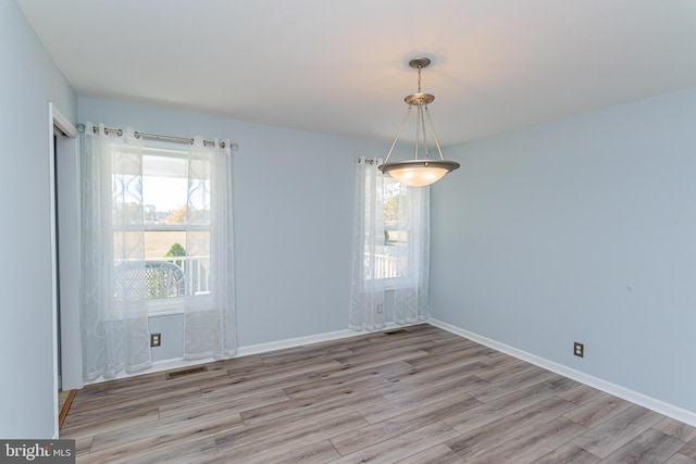 empty room with light hardwood / wood-style floors