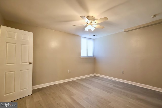 unfurnished room with hardwood / wood-style flooring and ceiling fan