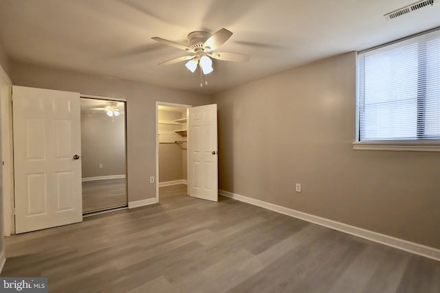 unfurnished bedroom with ceiling fan and hardwood / wood-style floors