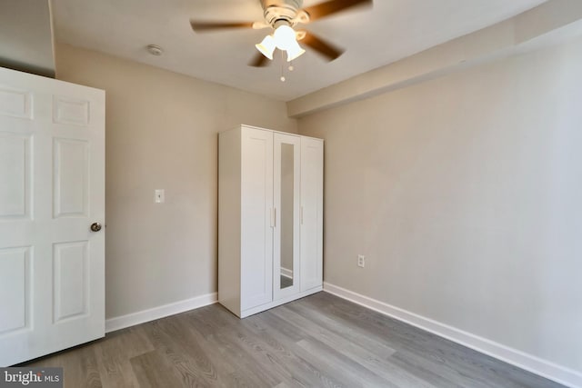 unfurnished bedroom with wood-type flooring and ceiling fan