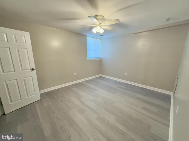 spare room featuring light hardwood / wood-style flooring and ceiling fan