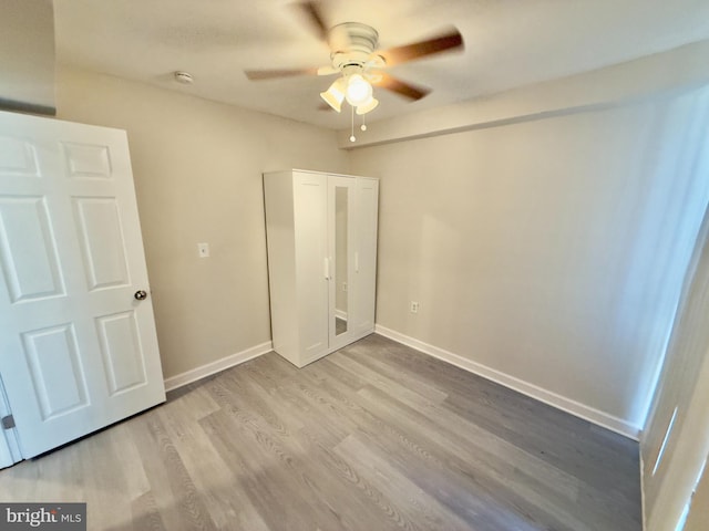 unfurnished bedroom featuring ceiling fan and light hardwood / wood-style flooring