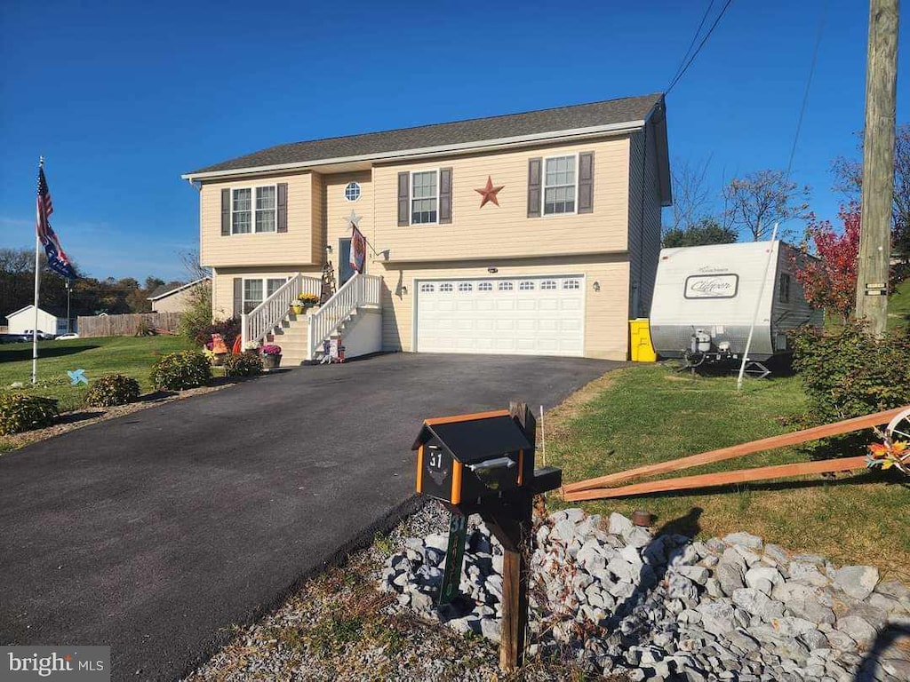 bi-level home featuring a front yard and a garage