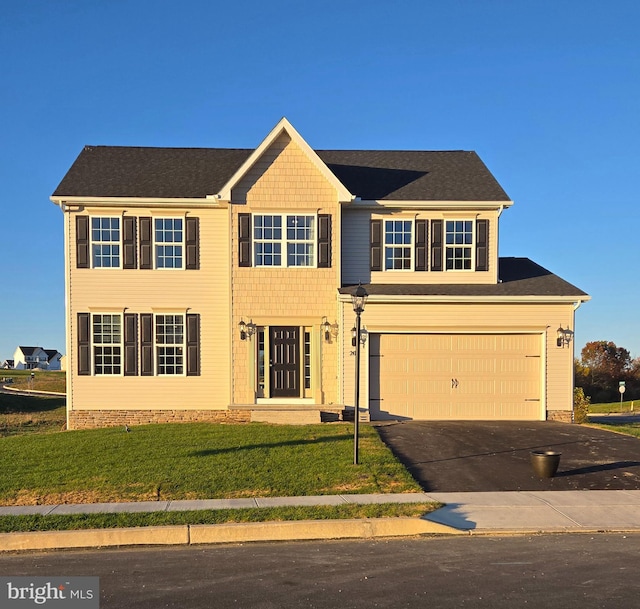 colonial inspired home featuring a front lawn