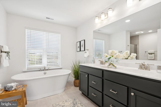 bathroom with vanity, shower with separate bathtub, and tile patterned flooring