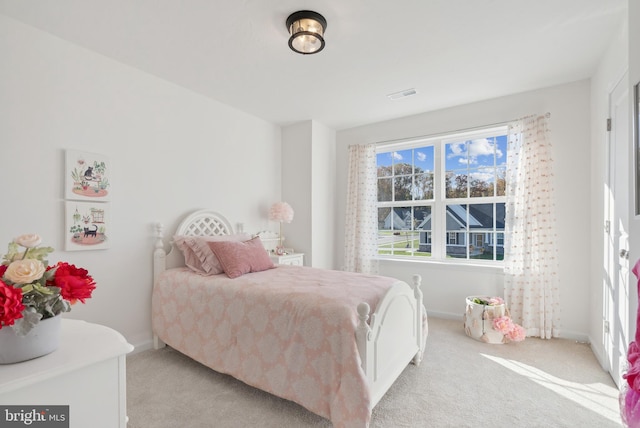 bedroom featuring light colored carpet