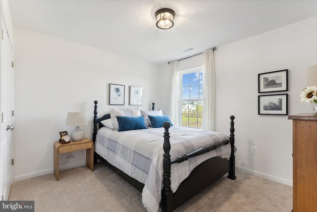 bedroom featuring light colored carpet