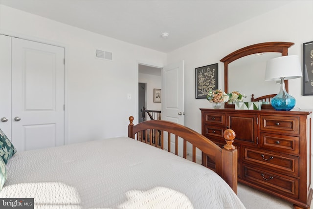 bedroom with a closet and light carpet