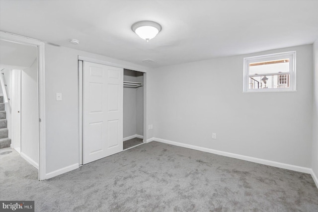 unfurnished bedroom with a closet and carpet