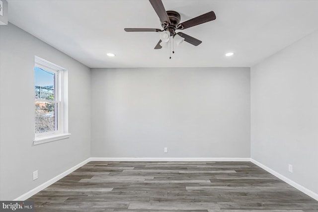 empty room featuring ceiling fan and dark hardwood / wood-style floors