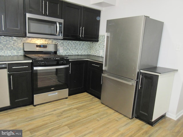 kitchen featuring tasteful backsplash, light hardwood / wood-style flooring, and stainless steel appliances