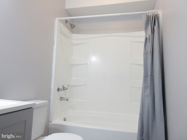 full bathroom with vanity, shower / tub combo, and toilet