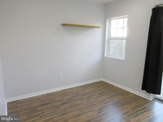 empty room featuring dark wood-type flooring