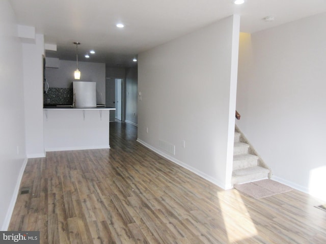 unfurnished living room with hardwood / wood-style flooring