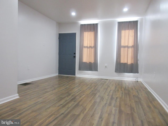 spare room with dark wood-type flooring