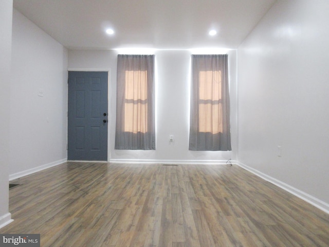 empty room with dark hardwood / wood-style floors