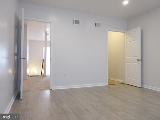 empty room with light hardwood / wood-style flooring