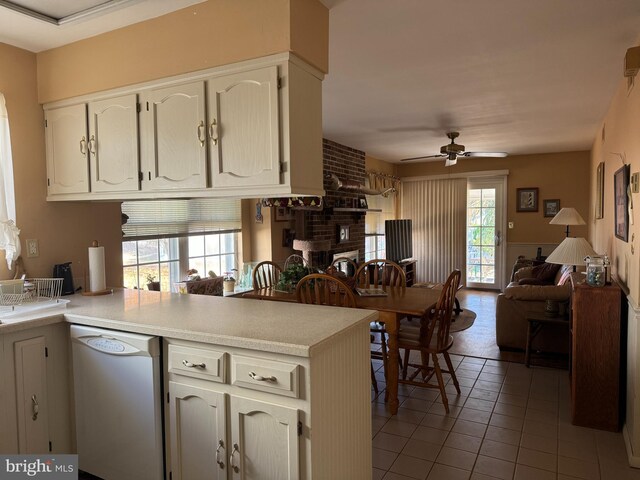 kitchen featuring kitchen peninsula, dishwasher, plenty of natural light, and ceiling fan