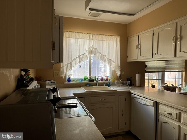 kitchen featuring sink, kitchen peninsula, dishwasher, and plenty of natural light