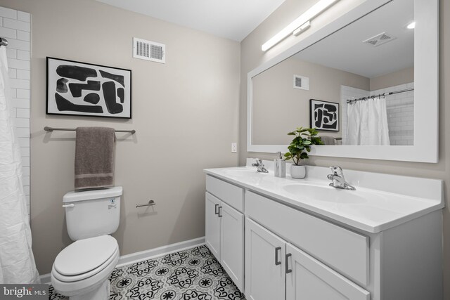 1020 N Eden St, Baltimore, MD 21205 - full bath featuring baseboards, toilet, double vanity, tile patterned flooring, and a shower with shower curtain