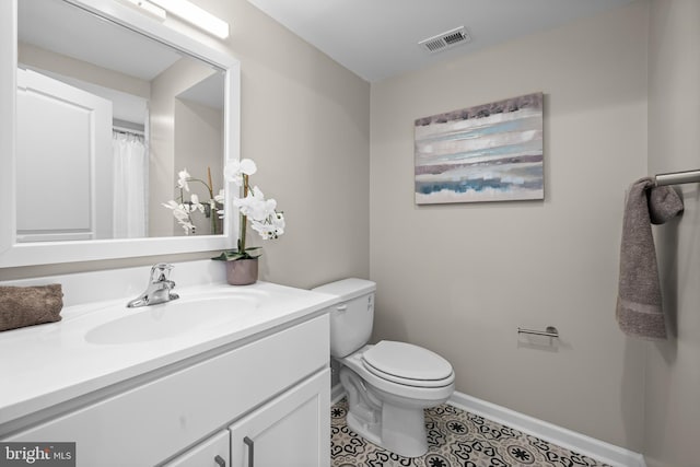 bathroom featuring vanity, toilet, and tile patterned floors