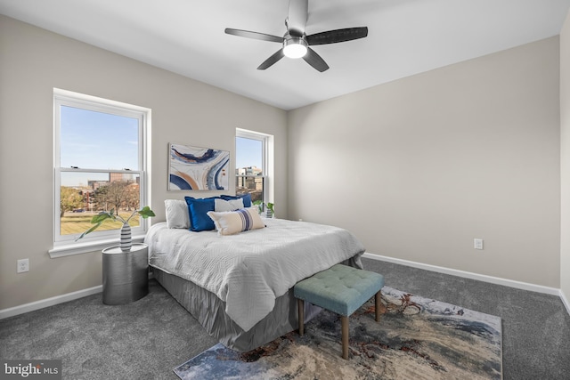 carpeted bedroom with multiple windows and ceiling fan