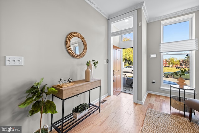 1020 N Eden St, Baltimore, MD 21205 - entrance foyer featuring plenty of natural light, ornamental molding, light wood-style floors, and baseboards