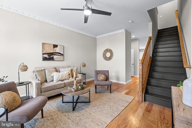 1020 N Eden St, Baltimore, MD 21205 - living area with stairs, ceiling fan, light wood-style floors, crown molding, and baseboards