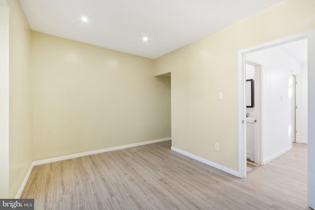 spare room featuring light hardwood / wood-style floors