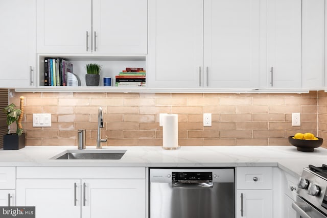 kitchen featuring decorative backsplash, white cabinetry, stainless steel appliances, sink, and light stone counters