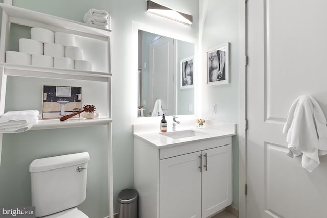 bathroom featuring toilet and vanity