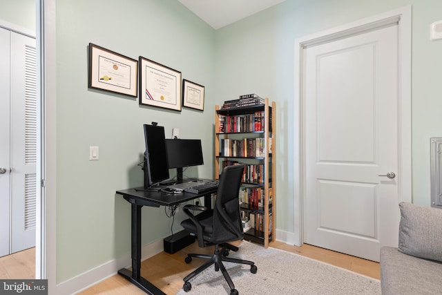 home office with light hardwood / wood-style floors