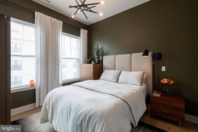 bedroom featuring wood-type flooring and multiple windows