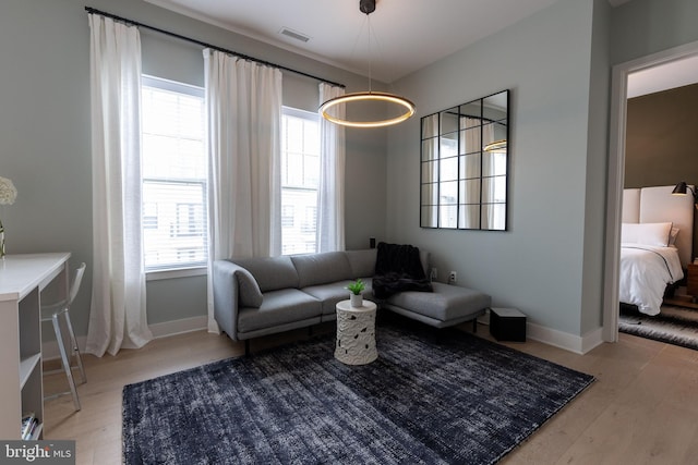 living area with hardwood / wood-style floors and a wealth of natural light