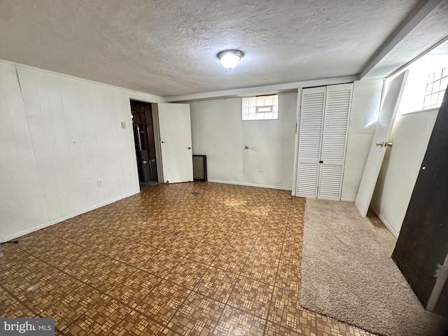 below grade area featuring a textured ceiling